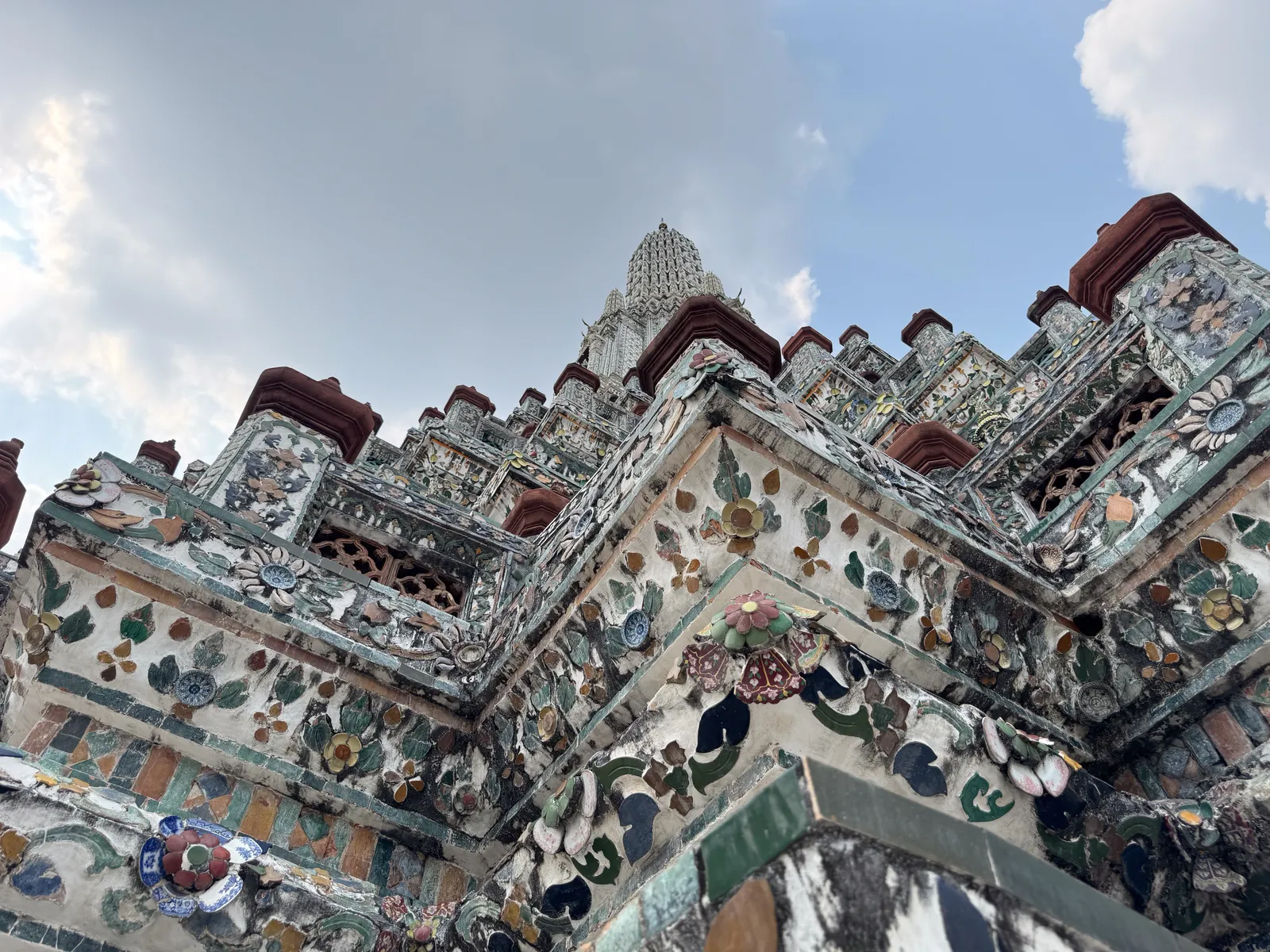 Mosaikverzierte Türme des Wat Arun in Bangkok von unten fotografiert
